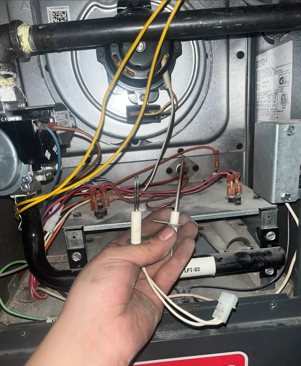 Furnace igniter component being inspected during service