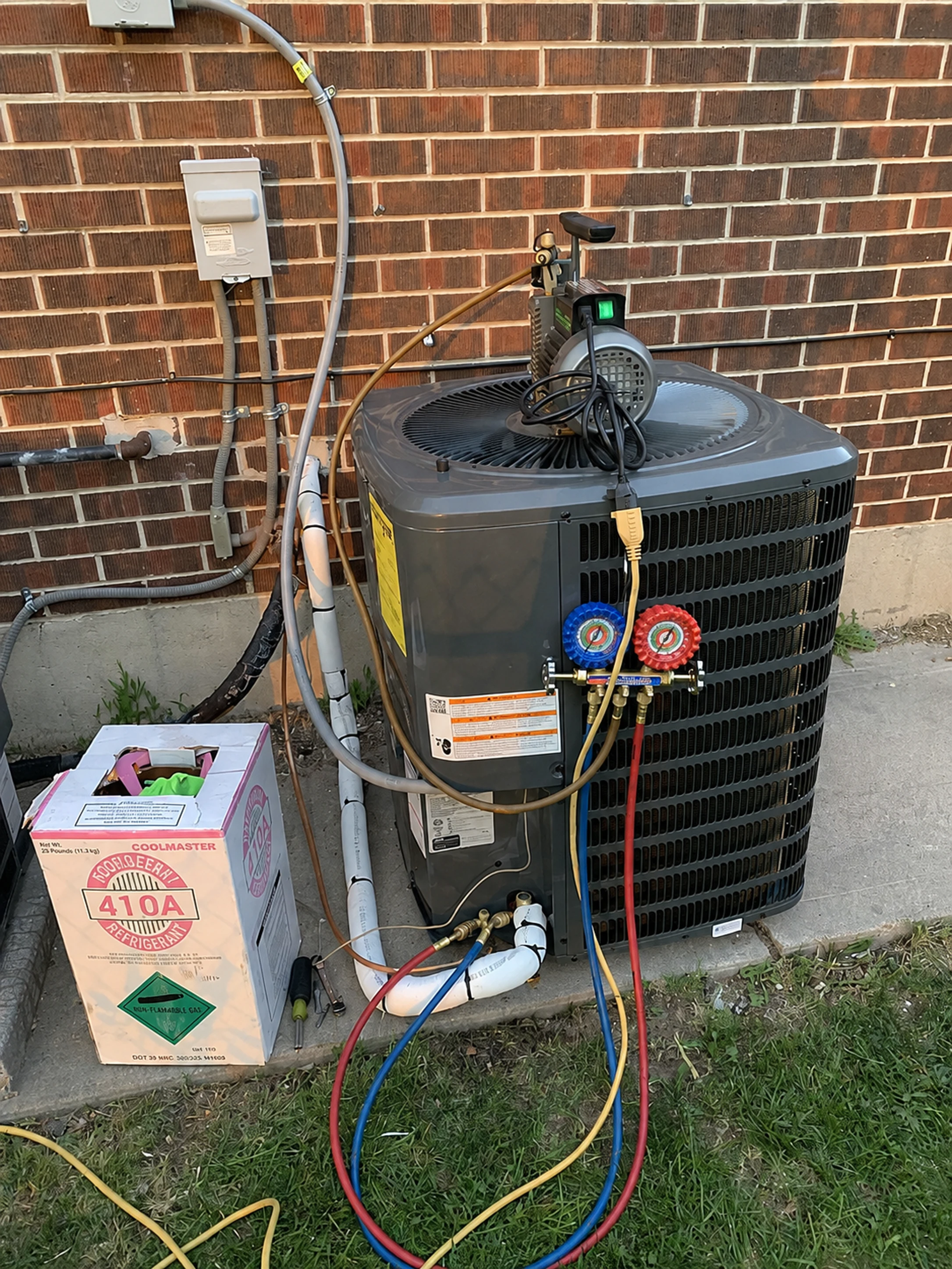 Outdoor air-conditioning condenser connected to service gauges