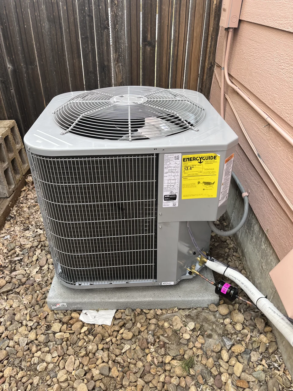 The replacement outdoor air-conditioning unit beside the house