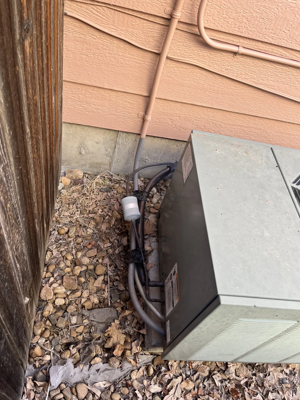 The existing outdoor air-conditioning unit beside the house