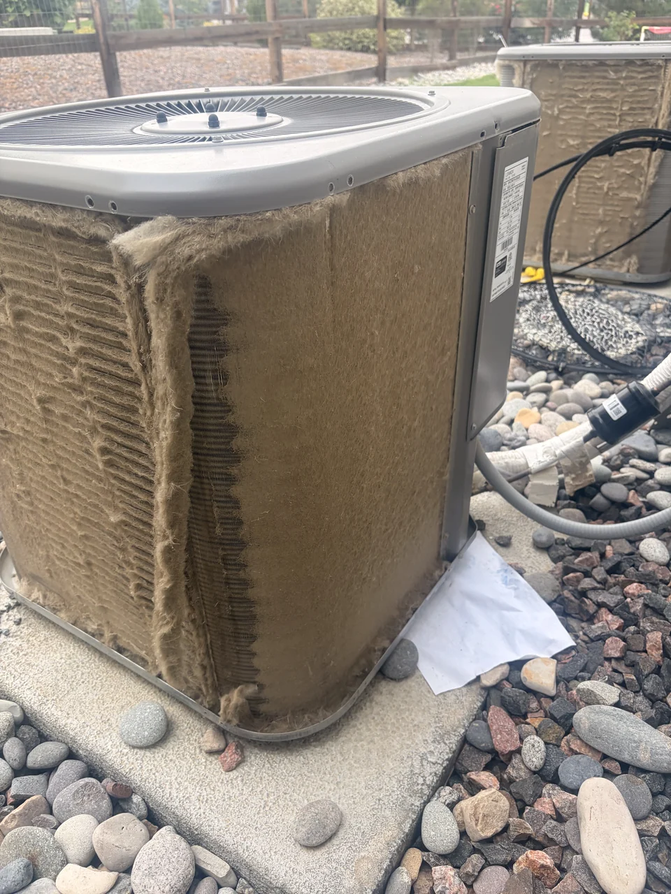 Outdoor air-conditioning coil with visible buildup before cleaning