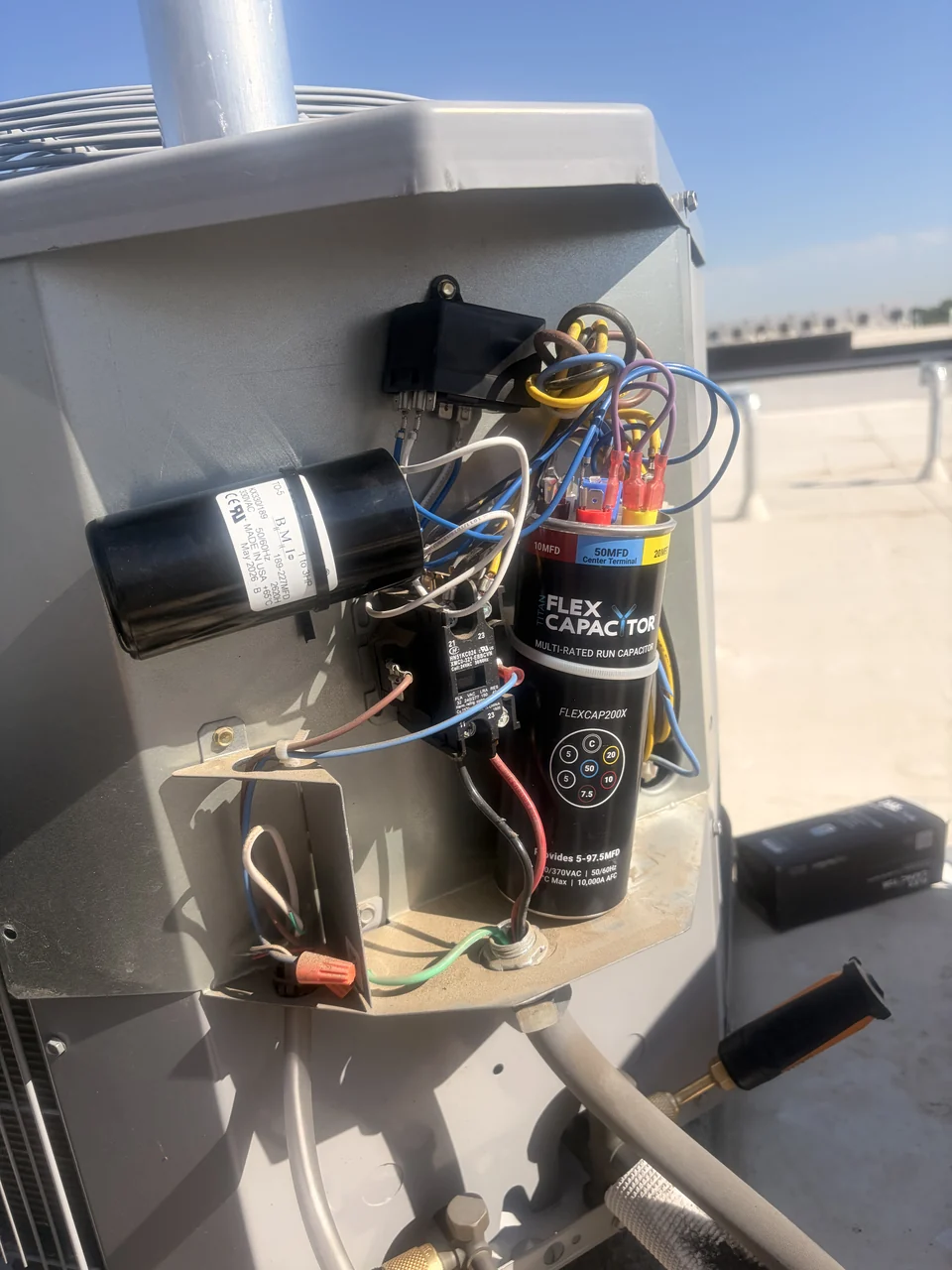 Capacitor and wiring inside an outdoor air-conditioning unit