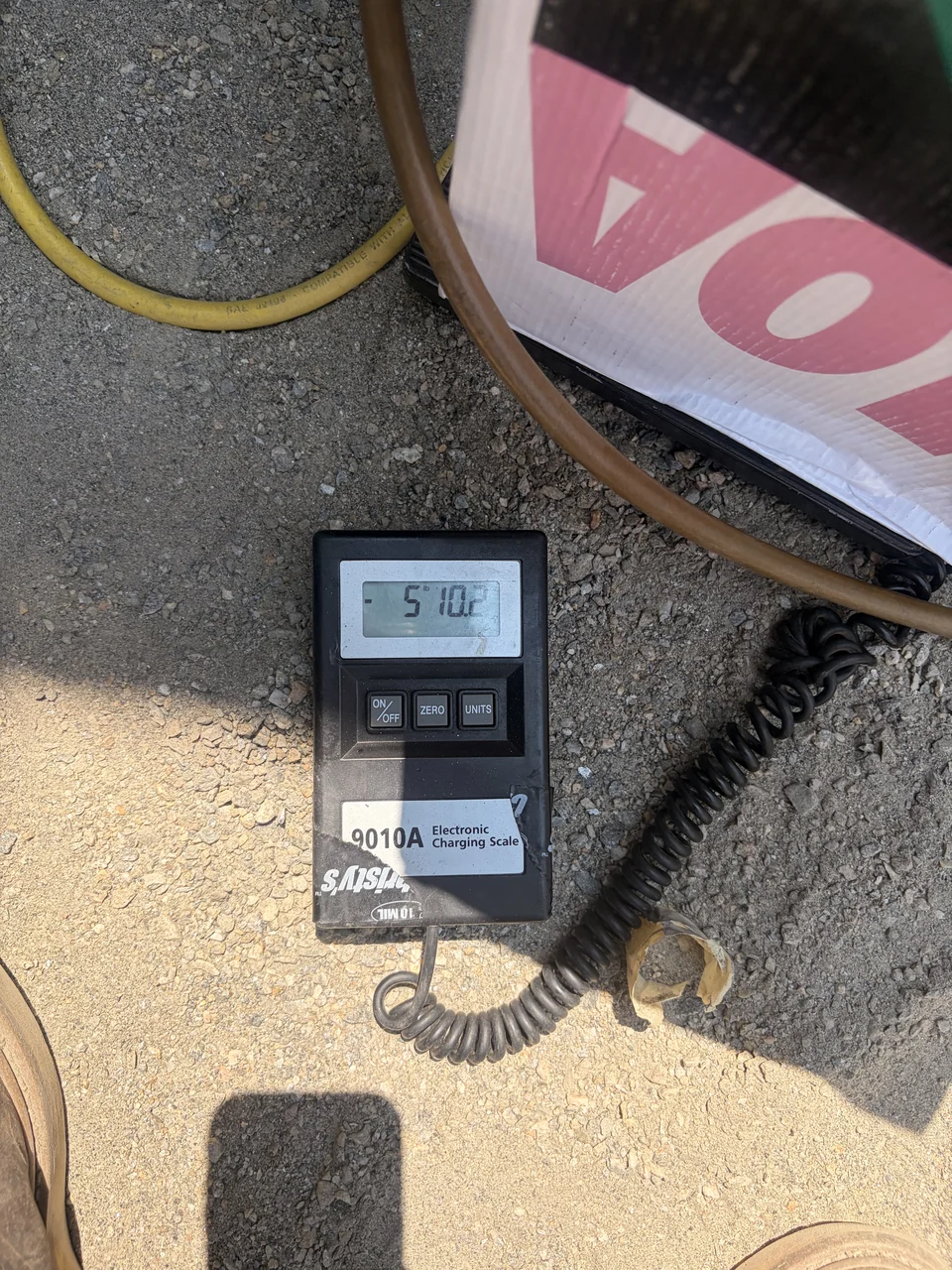 Refrigerant scale and hoses used during HVAC service